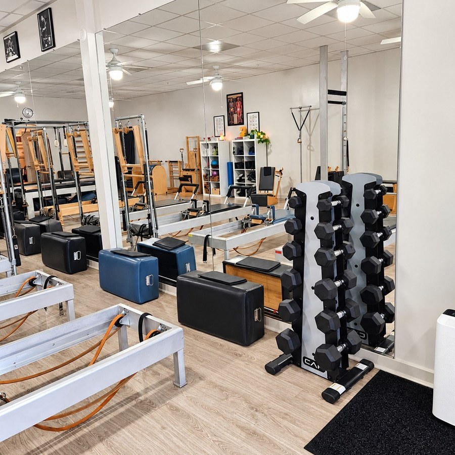 Pilates reformers, studio mirrors, and equipment inside International Pilates Center